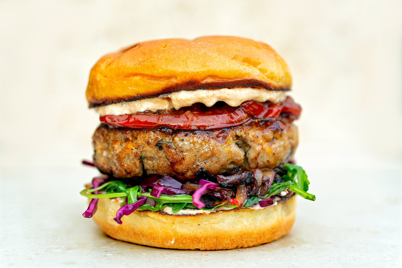 Pink Pepper Pork Burger Harissa feta sauce and red cabbage slaw
