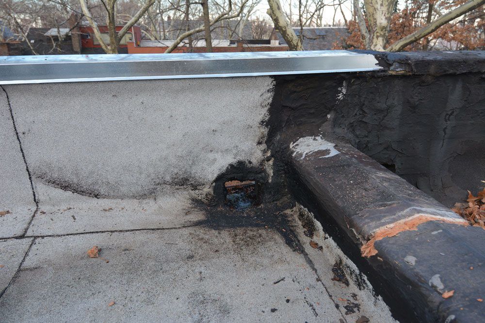 Scupper Was Not Properly Attached To The Flat Roof Membrane Queens