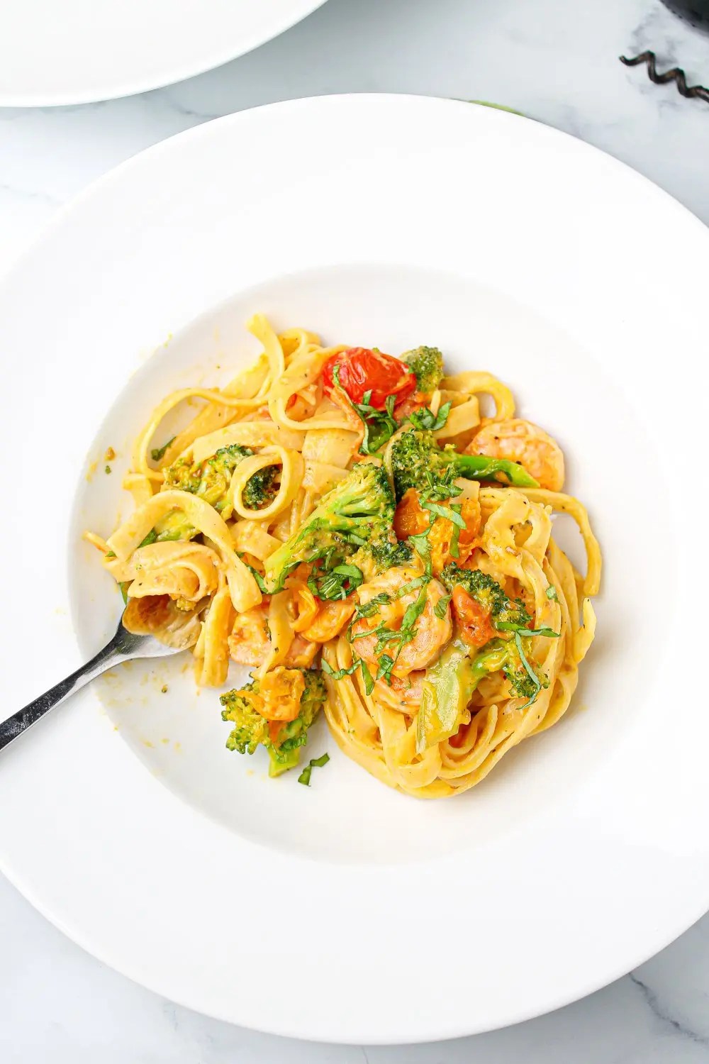 Creamy King Prawn Tagliatelle with Broccoli and cherry tomatoes Fork