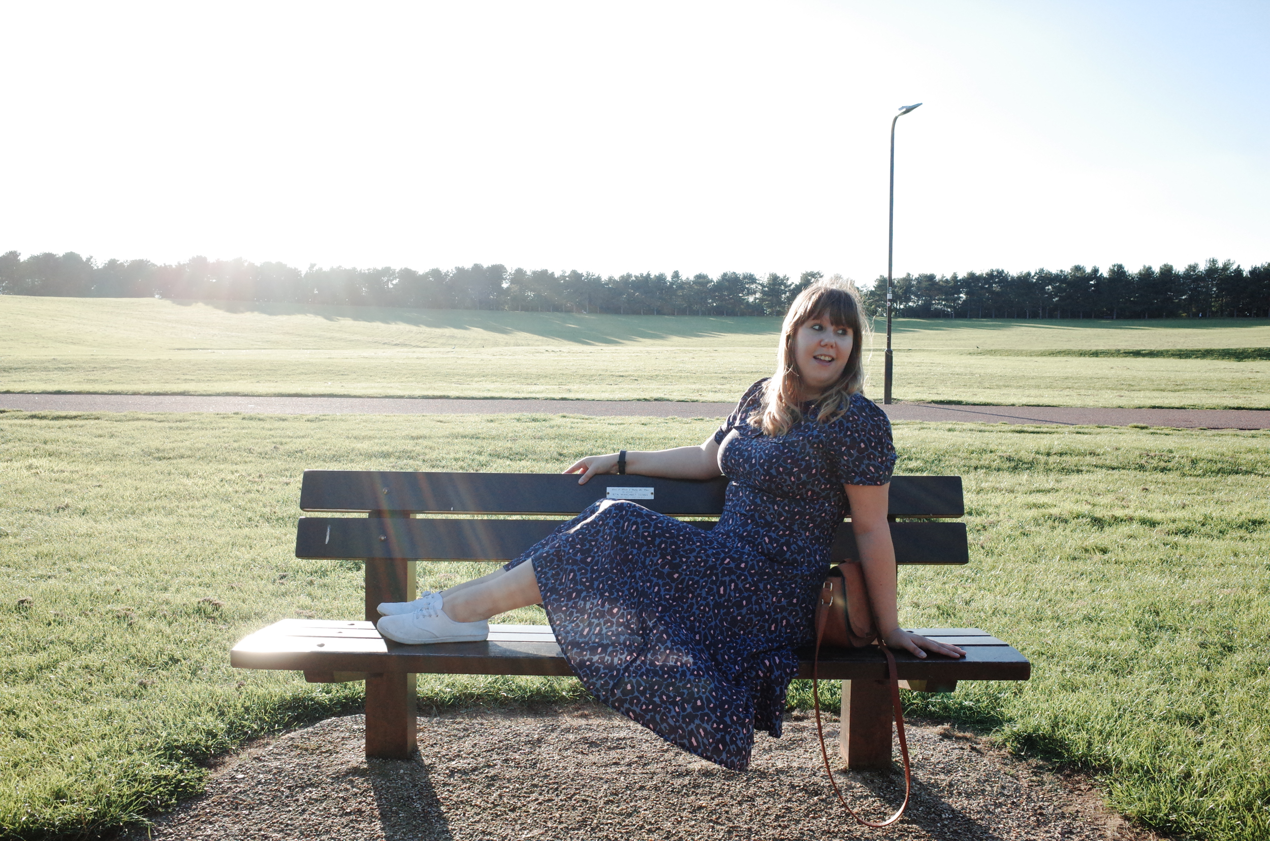 Posing on a bench wearing Joe Brown's Touch Of Pink dress