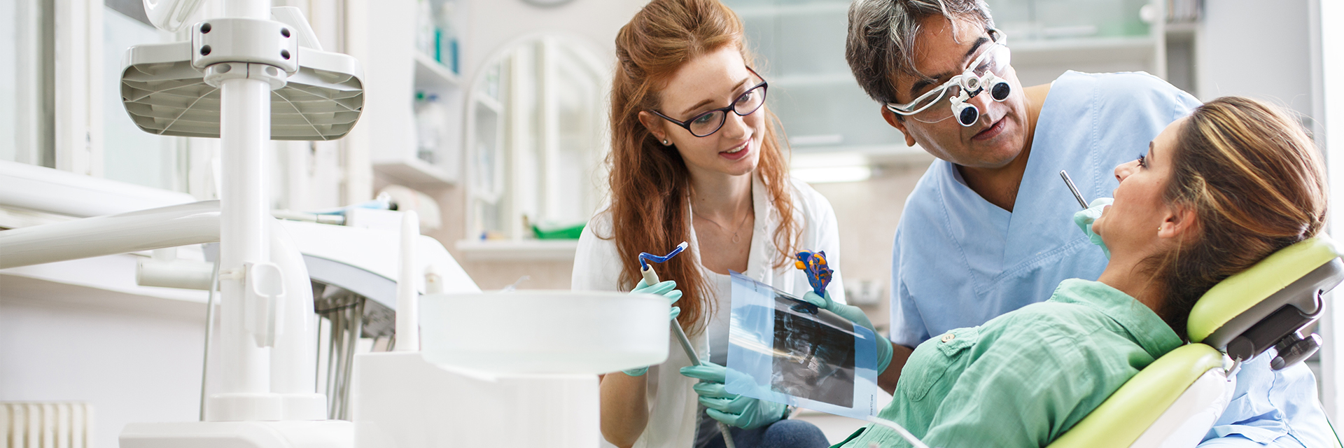 dentist and dental assistant consulting with a patient Fort Dental