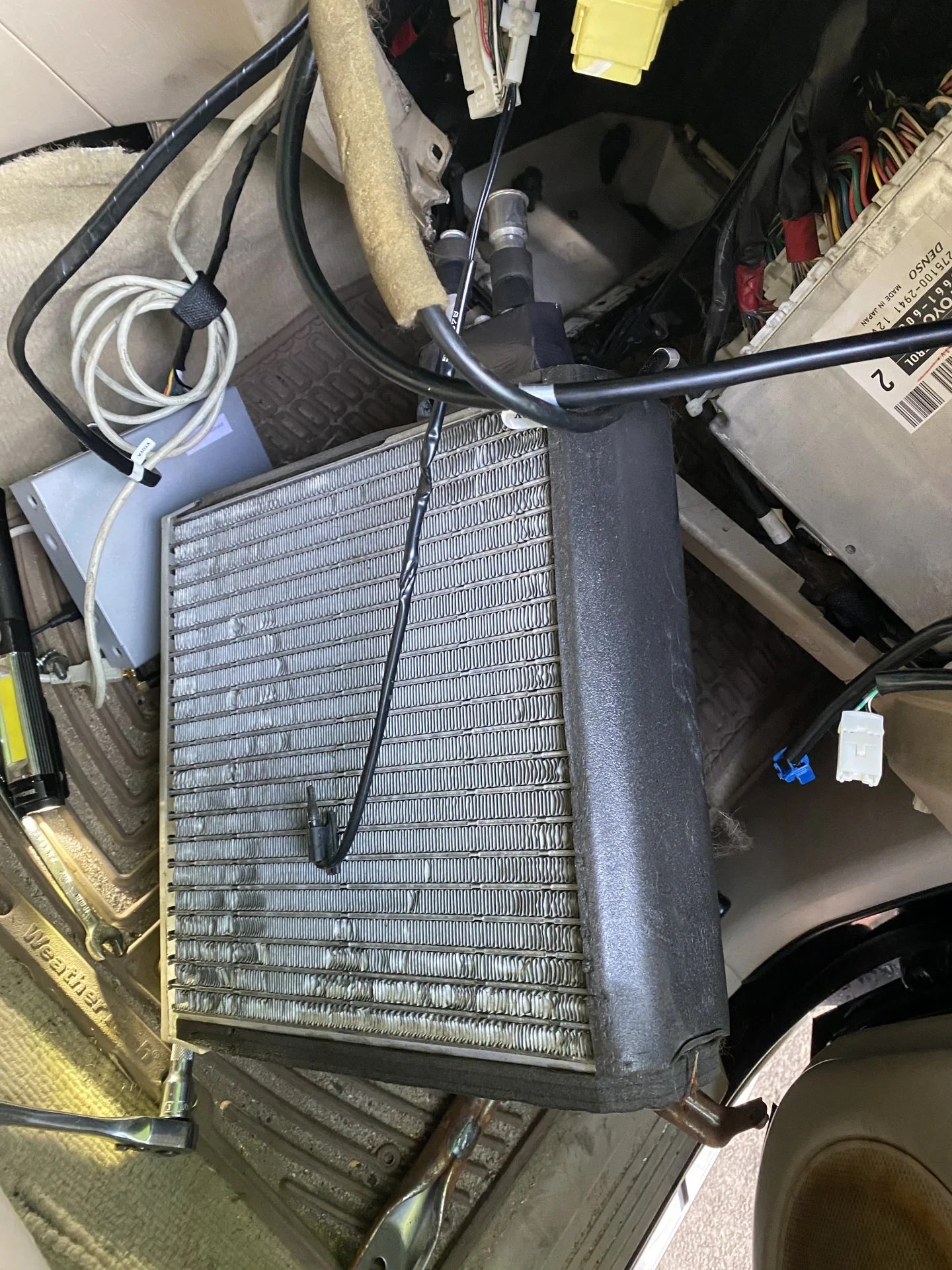 Where exactly does the evaporator temperature sensor clip on to