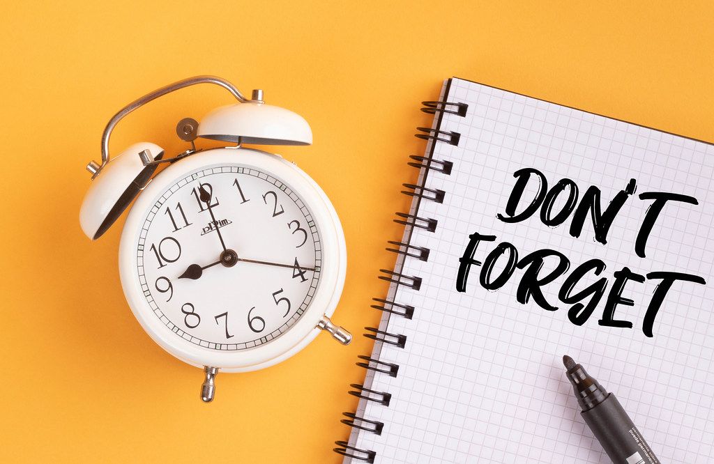 Alarm clock with handwritten Career Planning List on yellow background