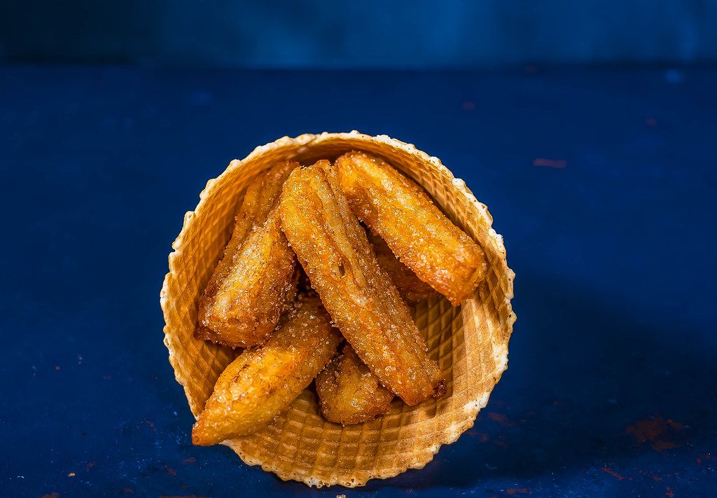 Two fried Belgian waffles with fresh fruit and chocolate syrup