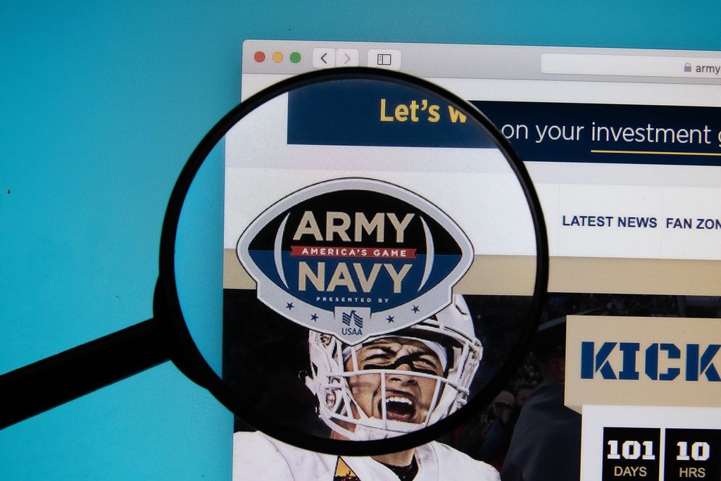 ArmyNavy Game logo on a computer screen with a magnifying glass