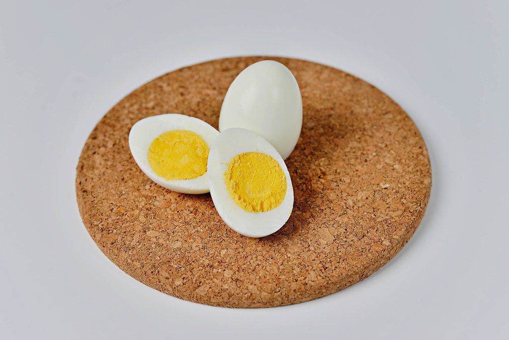 boiled egg cut in half on a cork table mat Creative Commons Bilder