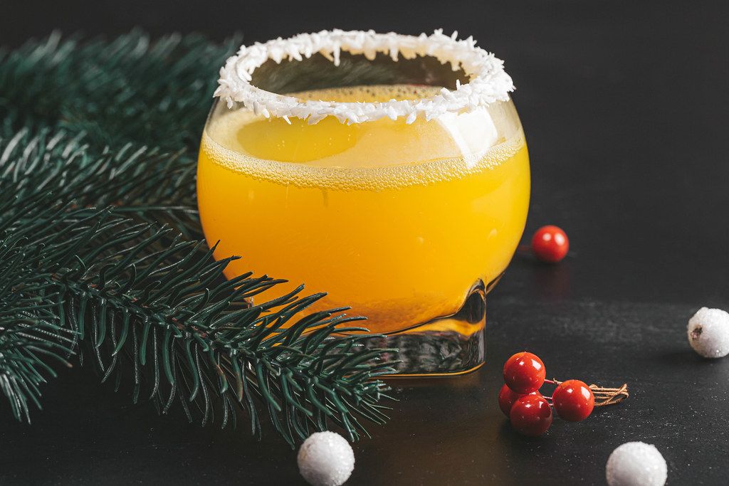 Orange cocktail on a new year background with Christmas tree branches Creative Commons Bilder