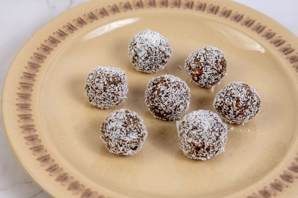 Energy Balls with Dates and Peanut Butter in the Coconut Creative