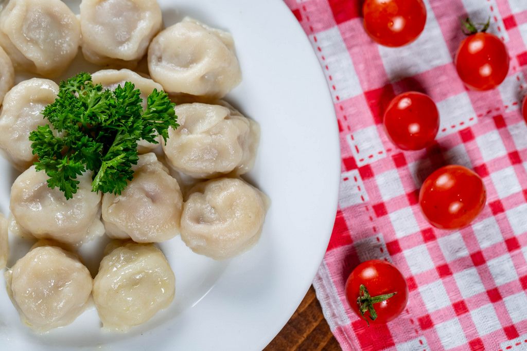 Woman's hand preparing dumplings. A preparation process of half