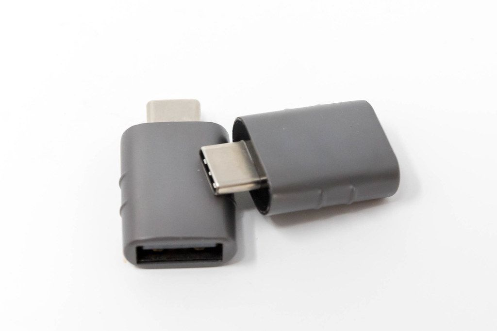 Hand holds the small USB adapter from Syntech, for USBC and USBOTG