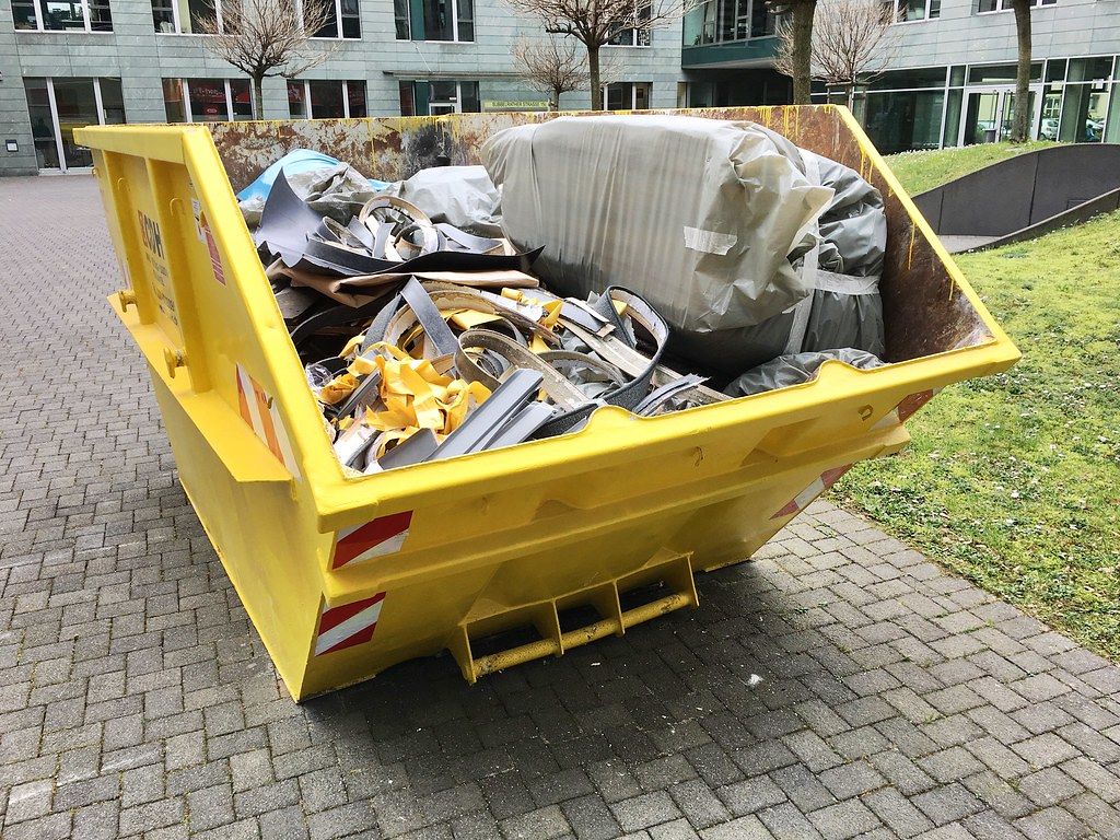 Large Yellow Trash Container filled with Construction Waste Creative