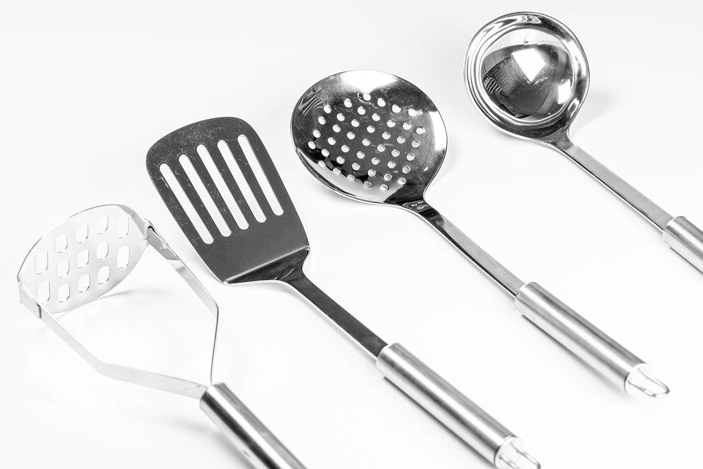 Top view of Kitchen Utensils with copy space above white paper