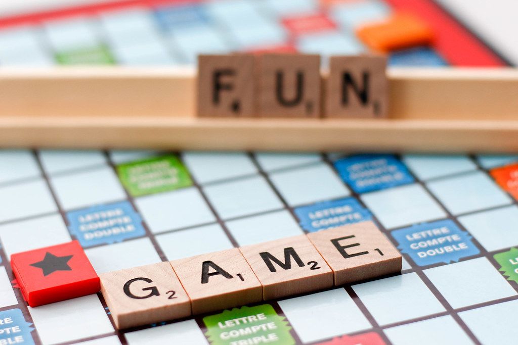 Close Up of Scrabble Board Game with Words Game and Fun Creative