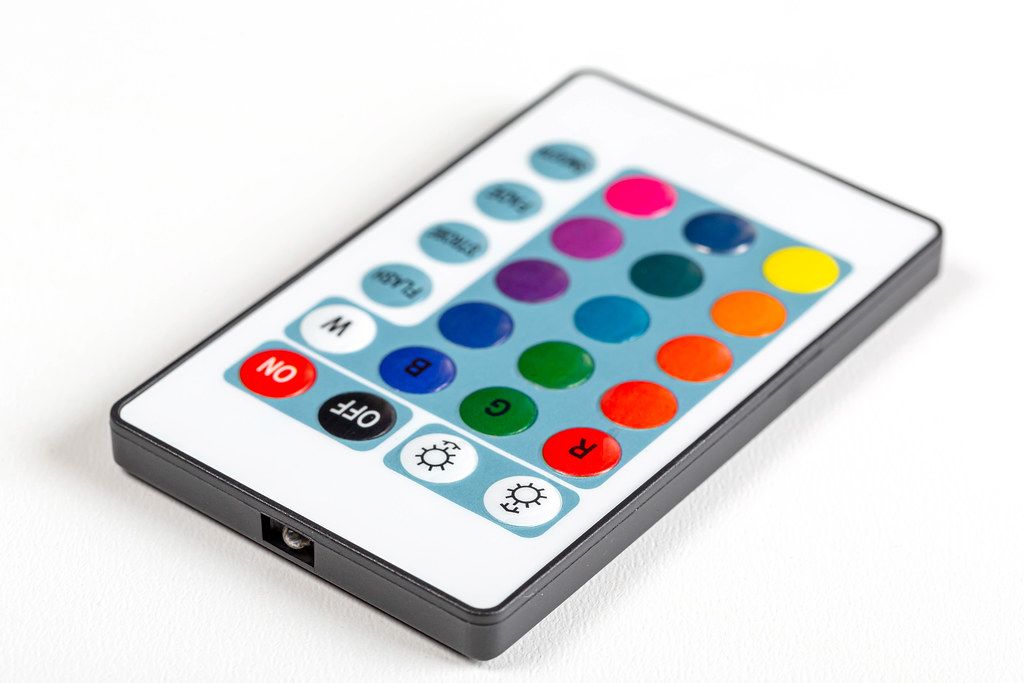 Remote control with multicolored buttons on a white background