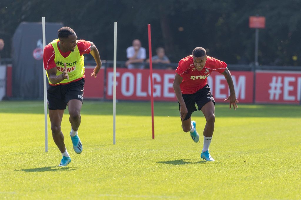 German soccer player during athletic running training outside on the soccer field Creative