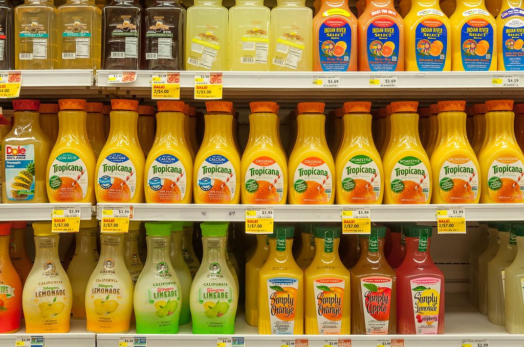 Shelf in a grocery store with different juice variations Creative