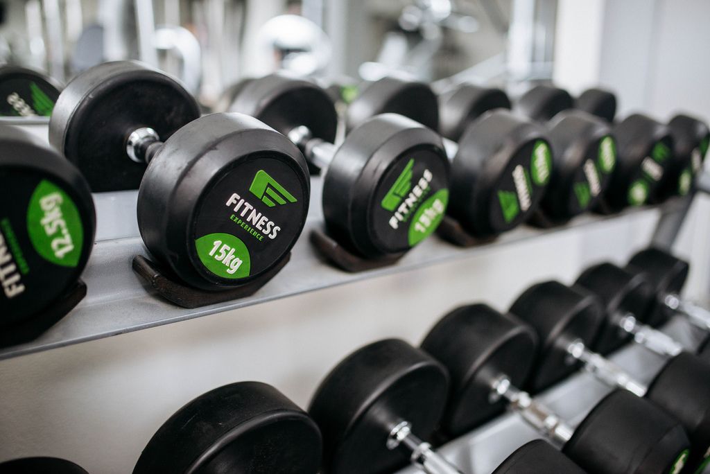 Colored dumbbells with different weights for home workout Creative