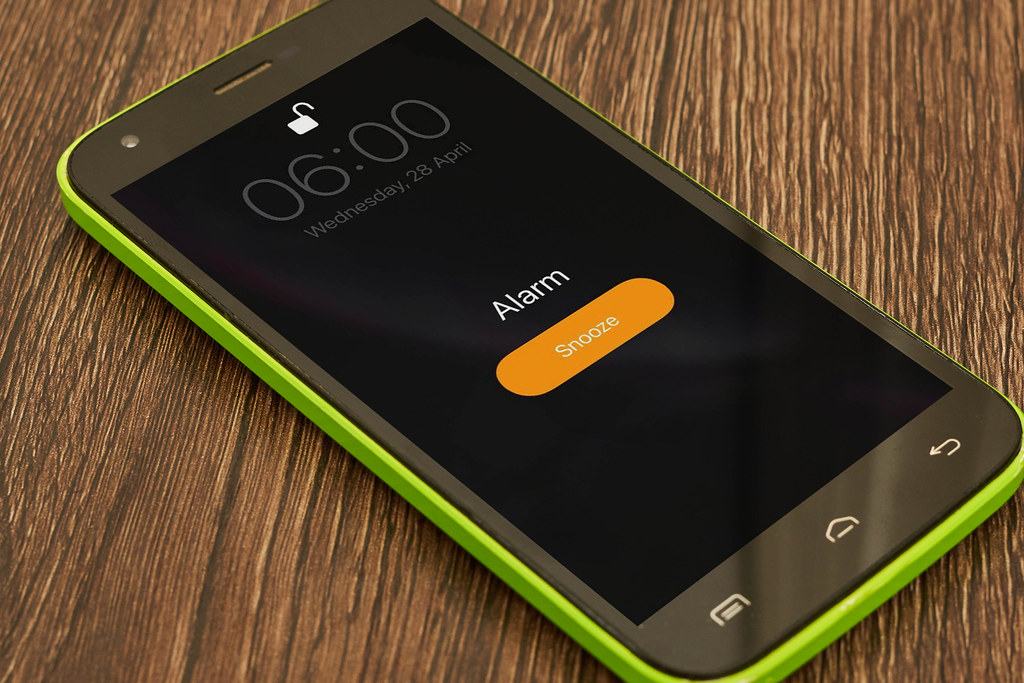 Ringing alarm clock on mobile phone with text wake up Creative