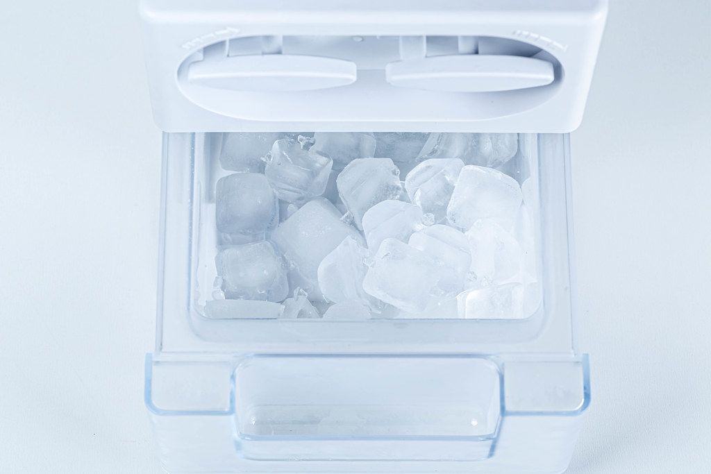 Ice from the fridge. Containers for ice in the refrigerator Creative