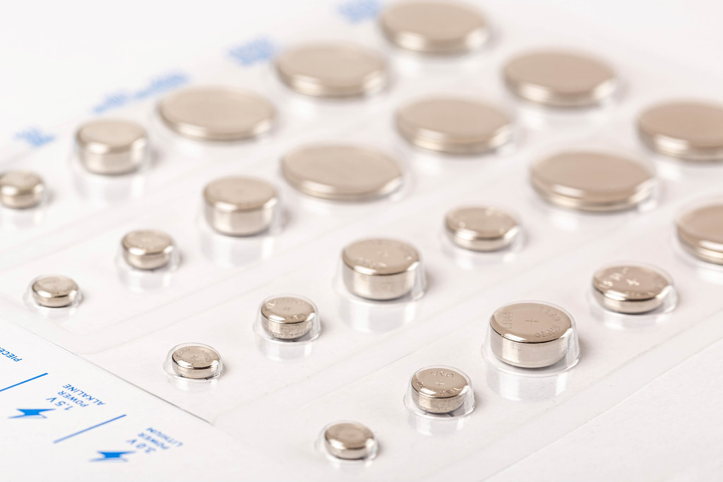 Set of round batteries of different sizes in a package Creative