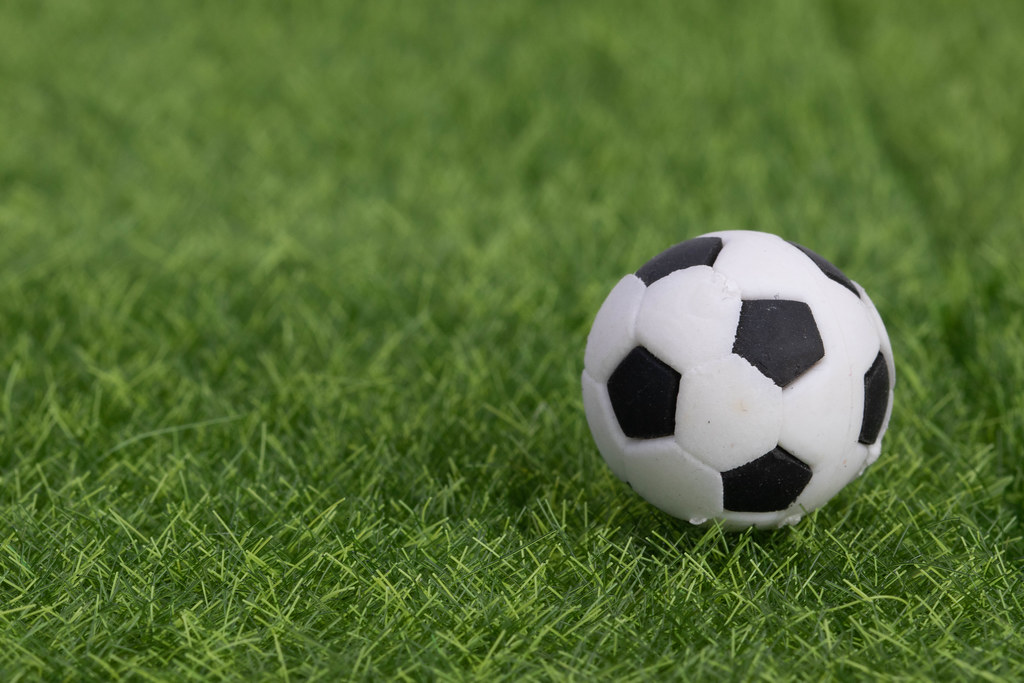 Soccer field tactics on a board with soccer ball and referee cards on