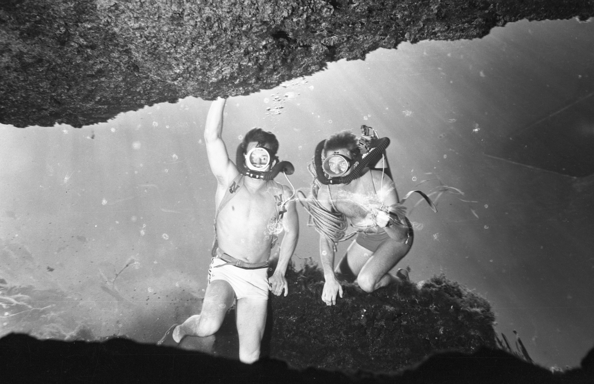 Florida Memory Divers near underwater rocks at Silver Springs.