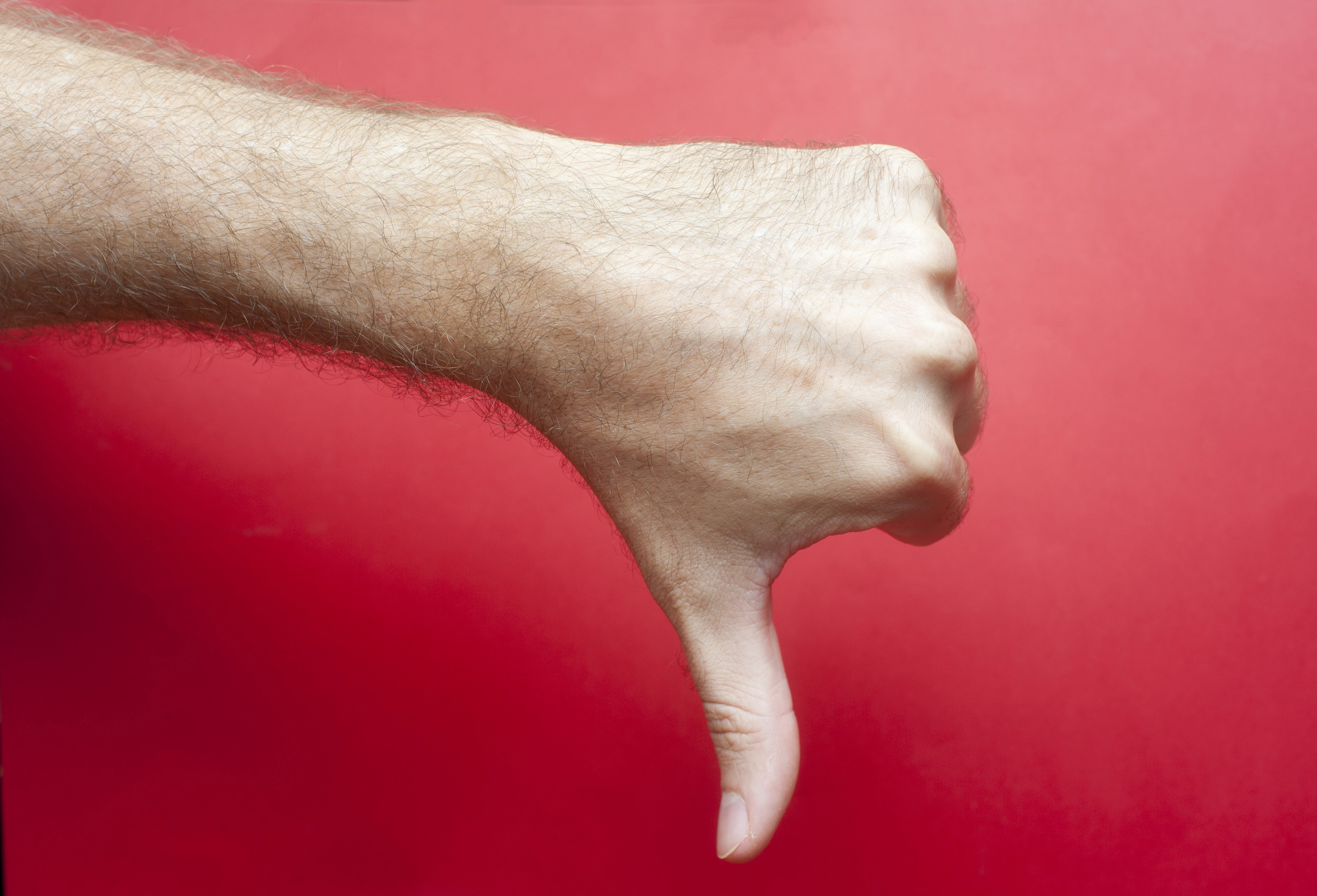 Free Image of Man making a thumbs down gesture Freebie.Photography