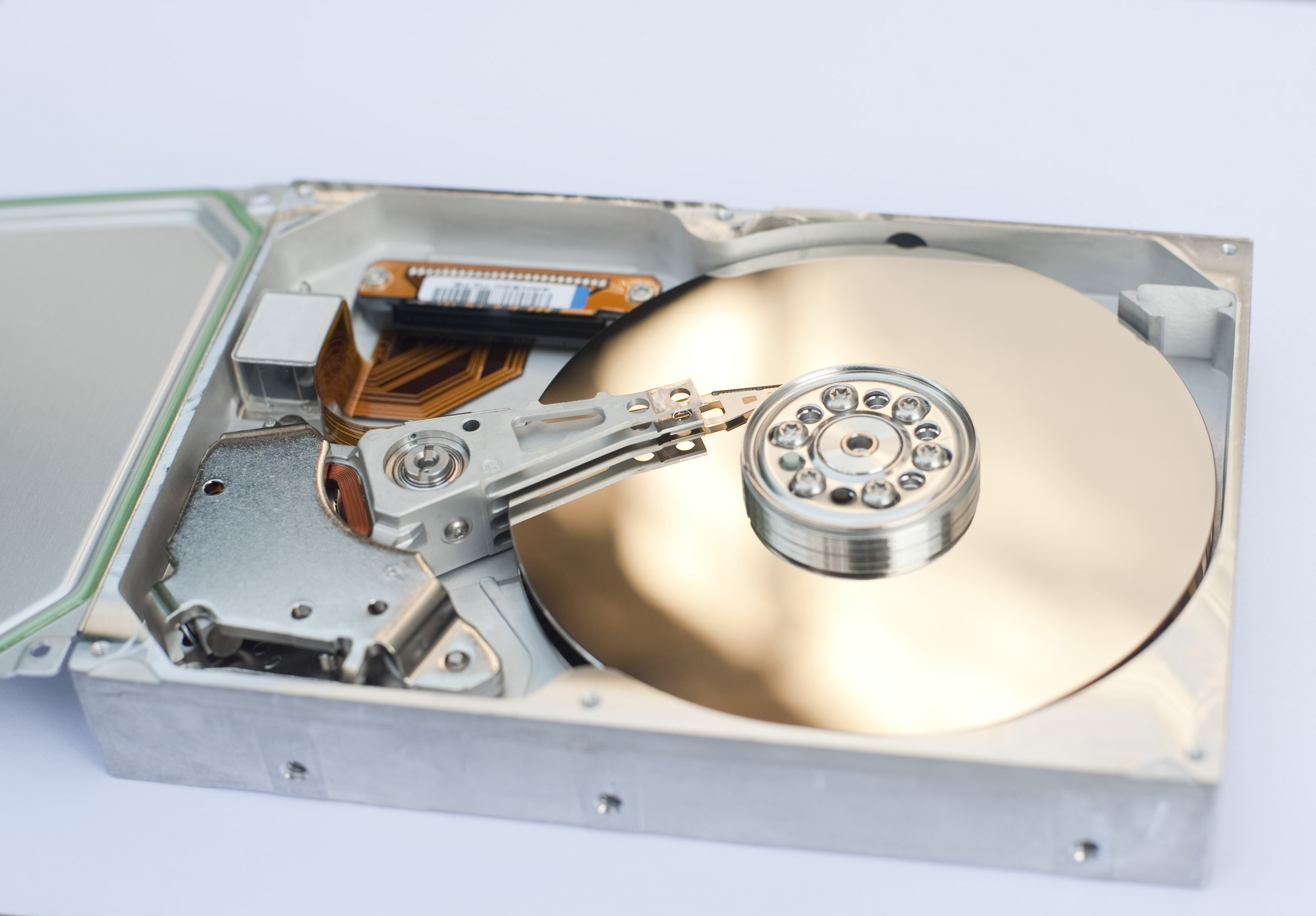 Free Image of Hard Drive with Gold Colored Disk Freebie.Photography