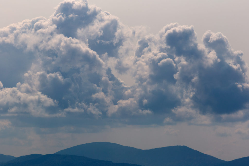 Moody Rolling Clouds Over Mountains • Free Nature Stock Photo