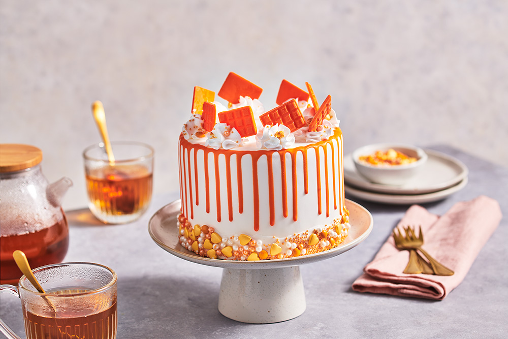 Orange drip cake with sprinkles and mini choco bars FunCakes