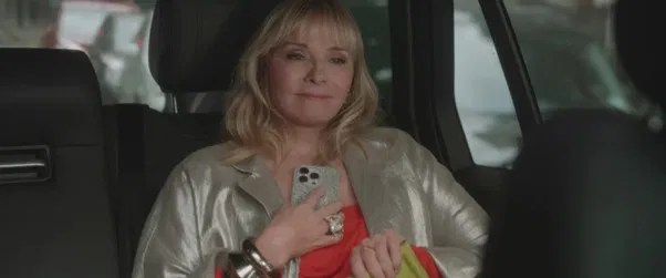 Samatha looking happy about something while sitting inside a car