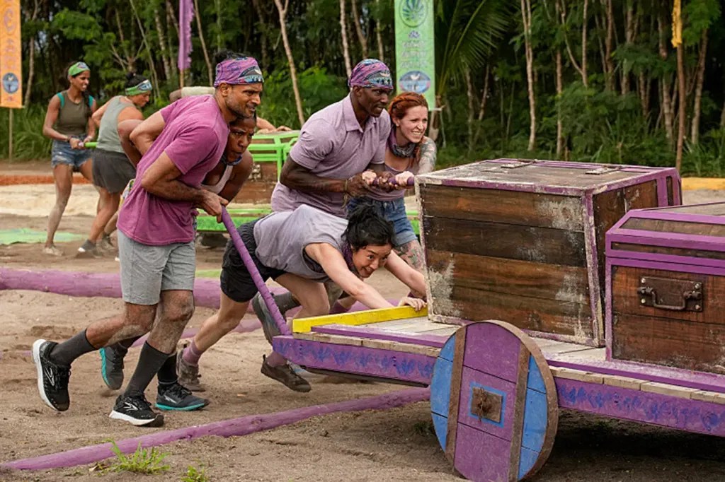The cast of Survivor playing a challenge