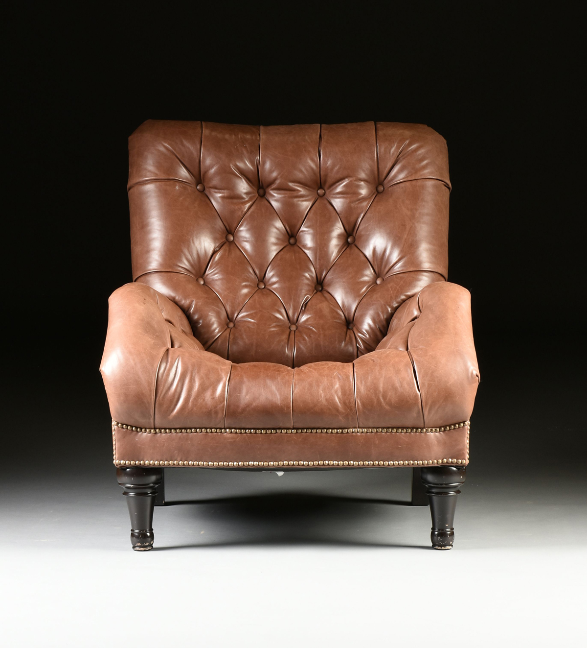Leather Reading Chair And Ottoman A CHESTERFIELD BROWN TUFTED LEATHER READING CHAIR AND OTTOMAN, 20TH