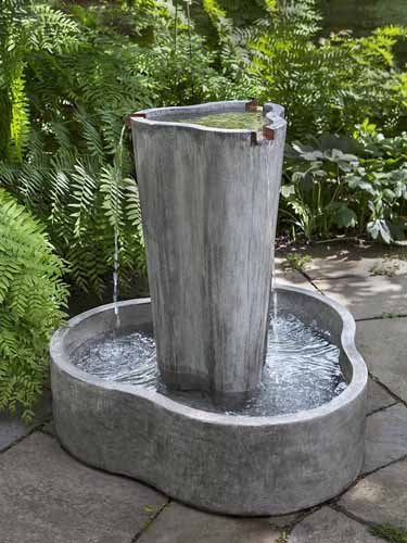 A close up of the Concrete LC2 Garden Terrace Fountain outdoors.