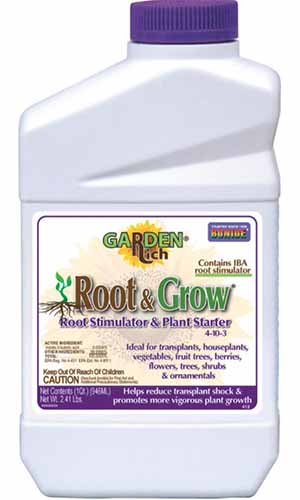 A close up vertical image of a plastic bottle of Bonide Garden Rich Root and Grow isolated on a white background.