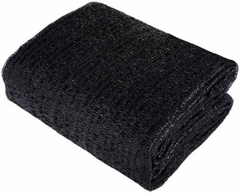 A close up horizontal image of black shade cloth isolated on a white background.