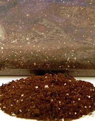 A close up square image of the packaging of OMRI potting soil isolated on a white background.