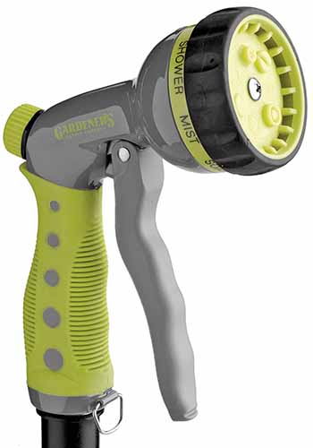 A close up square image of a squeeze spray hose nozzle isolated on a white background.