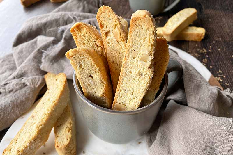 A close up of freshly homemade anise biscotti in a metal pot.