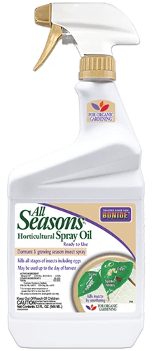 A close up of a spray bottle of Bonide horticultural oil isolated on a white background.