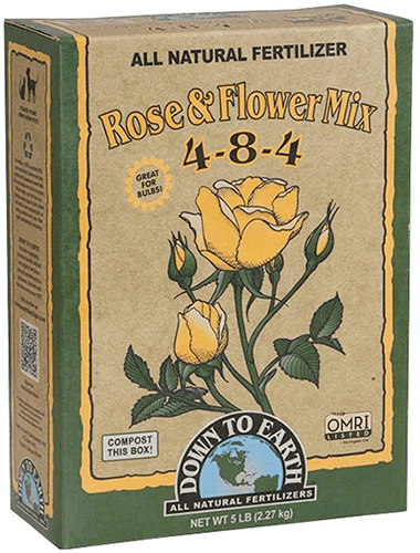 A close up of the packaging of Down to Earth Rose and Flower Mix fertilizer isolated on a white background.