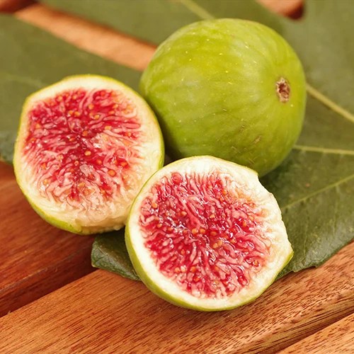 A close up square image of &lsquo;Desert King&rsquo; whole and sliced set on a wooden surface.