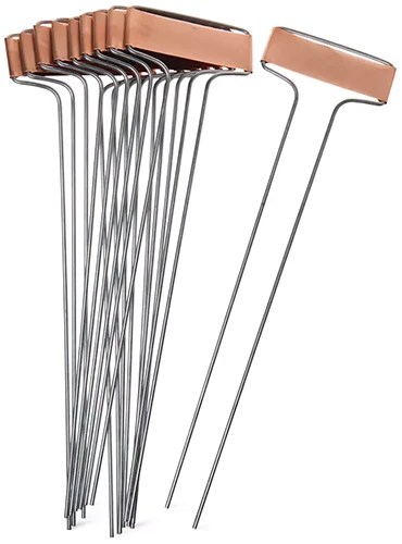 A close up of copper plant markers isolated on a white background.