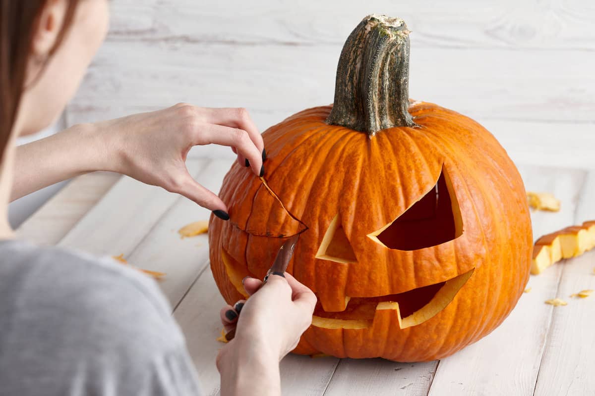 Woman designing a Jack O' Lantern