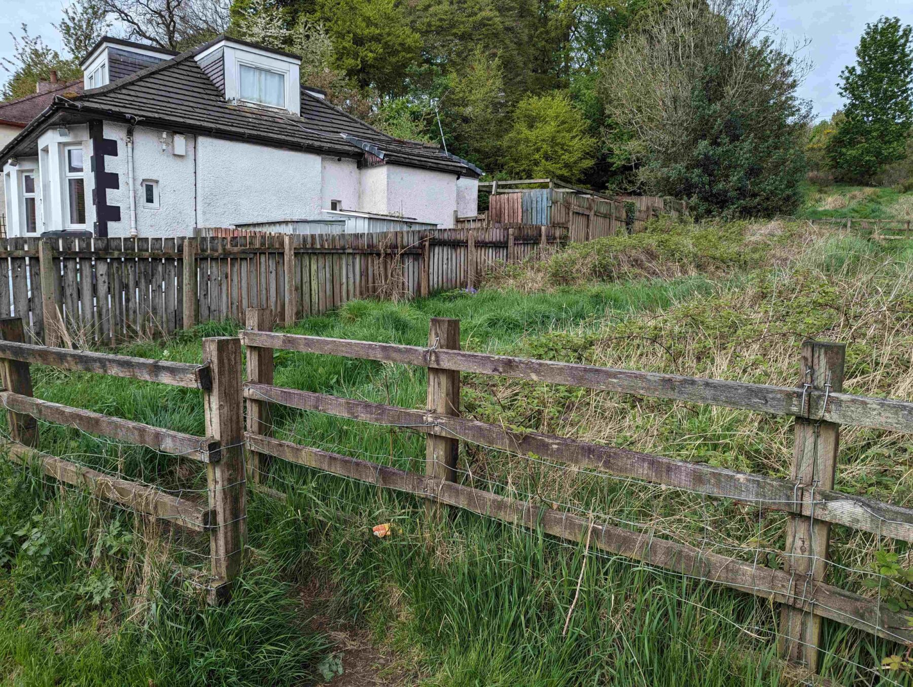 Wooden fence marking the start point of the Fereneze Braes trail in Barrhead