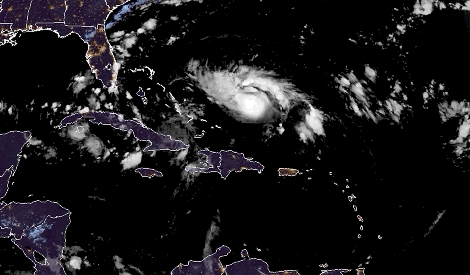 The sun comes up on strengthening Hurricane Dorian on Friday.