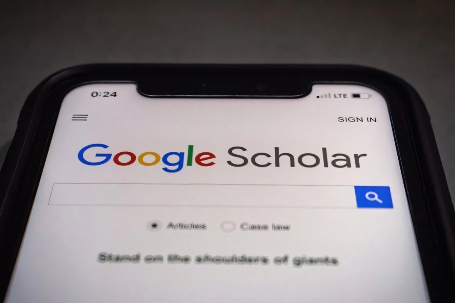 A phone on Google Scholar&rsquo;s landing page.