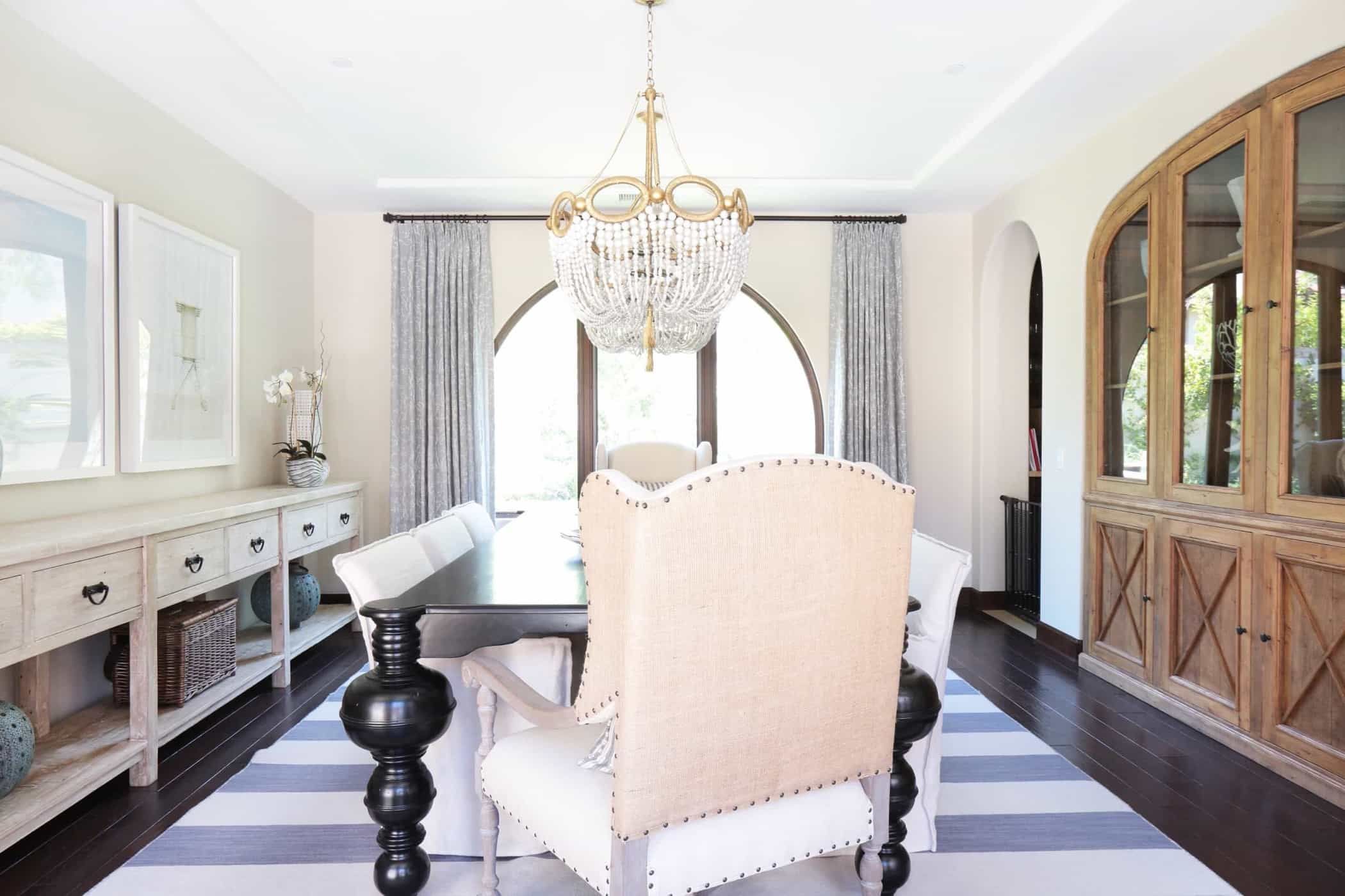 Neutral Coastal Dining Room With Striped Rug