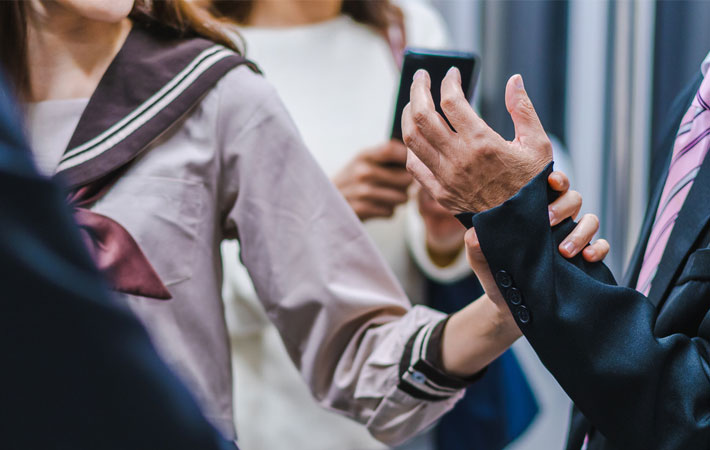 Japanese schoolgirl grabs man’s arm in crowded train but not for the