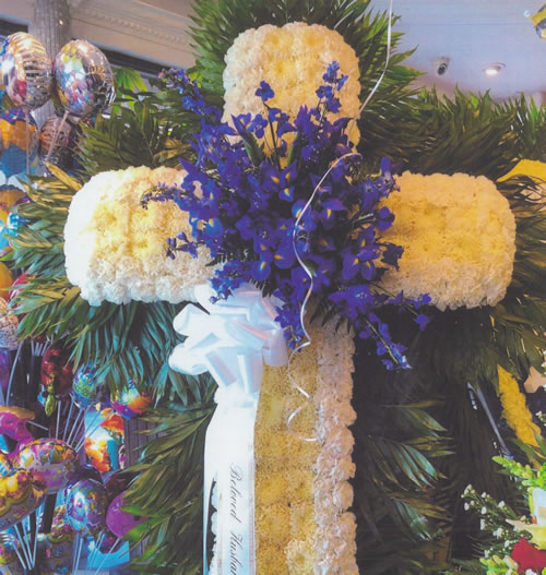 White, Yellow & Purple Flowers & White Ribbon Bow Cross Arrangement